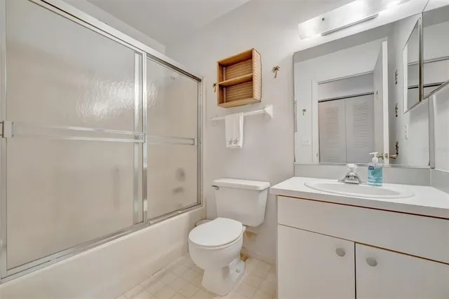 a bathroom with a toilet a sink and a mirror