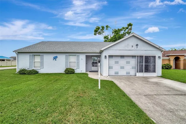 a front view of a house with a yard and garage