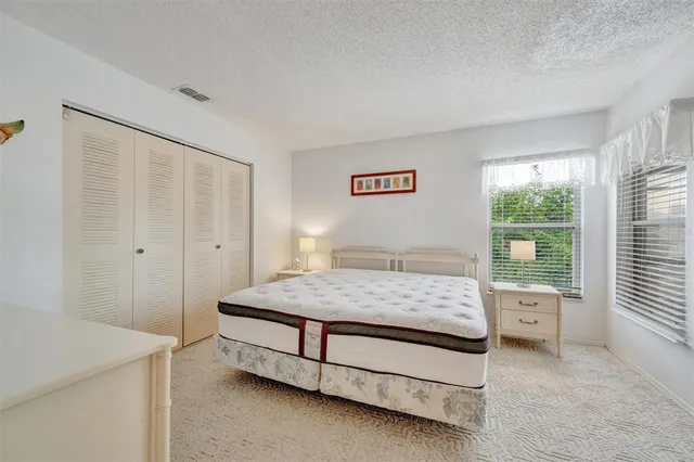 a bedroom with a bed and a table in it