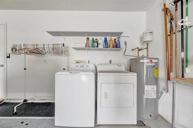 a utility room with cabinets dryer and washer