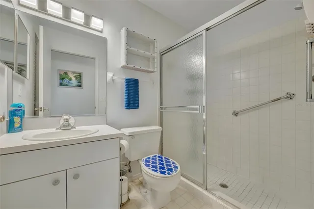 a bathroom with a sink mirror and shower