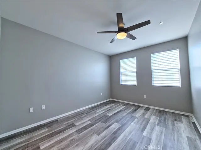 a view of an empty room and window with wooden floor