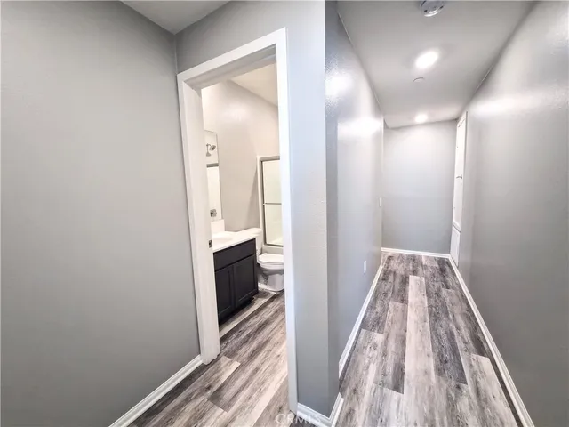 a view of entryway and hall with wooden floor