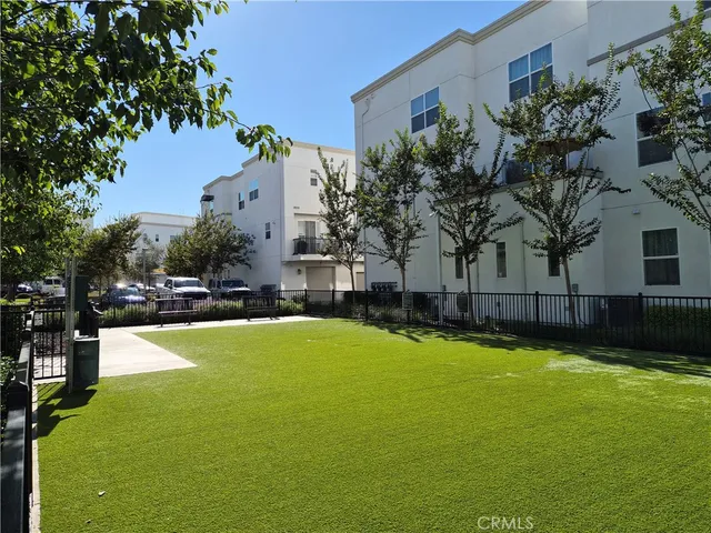 a view of a patio with couches and dining table and chairs with wooden floor