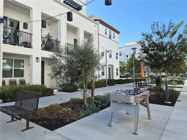 a view of a tennis ground with large trees