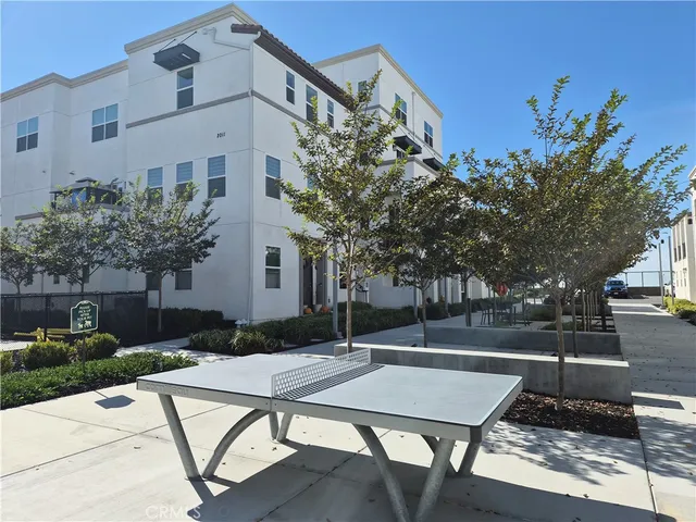 a view of a terrace with a table and chairs