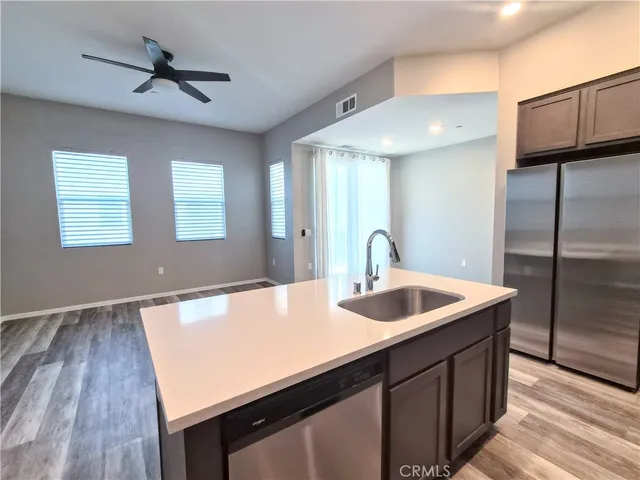 a kitchen with a sink and a refrigerator