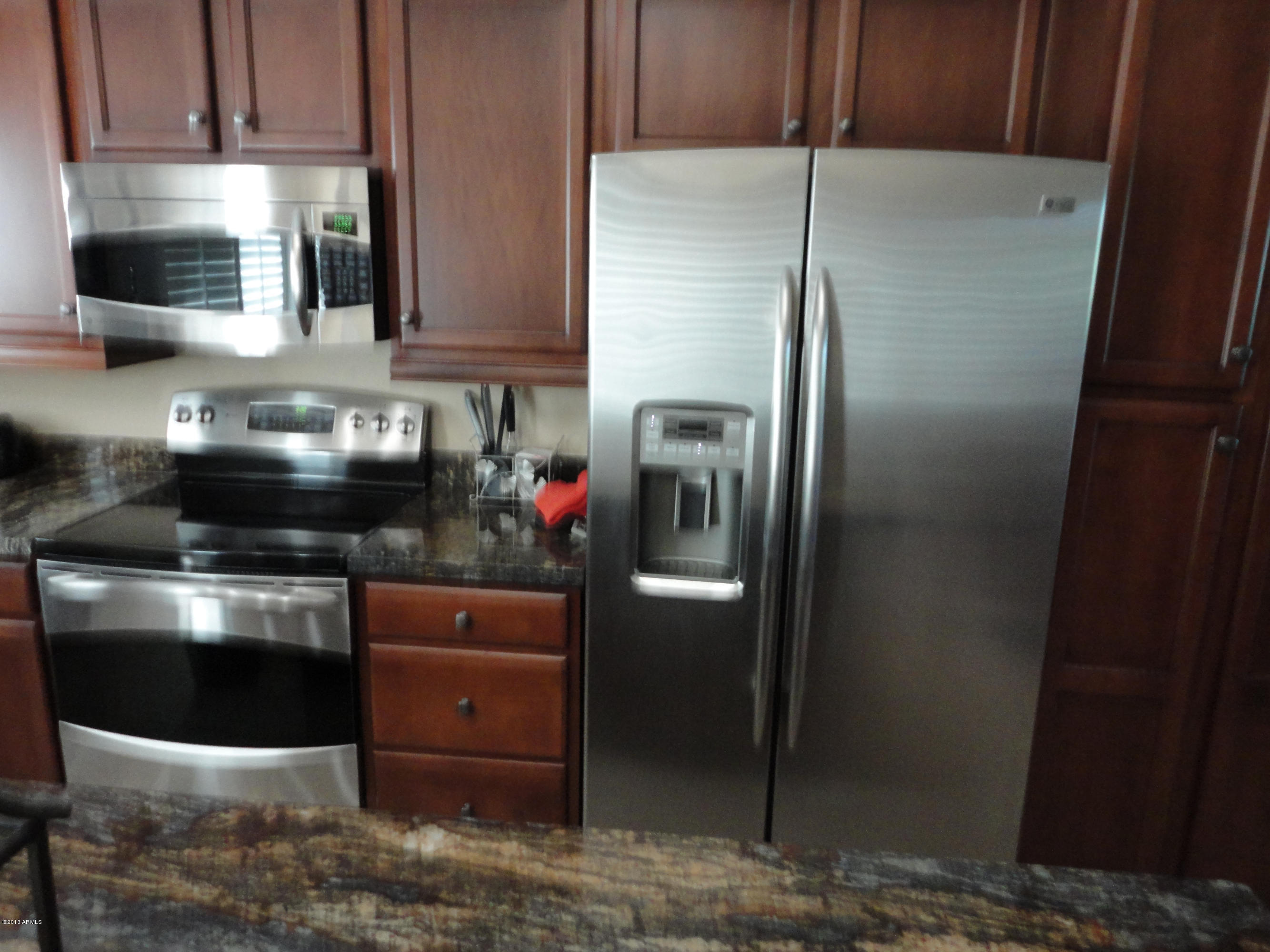3935 East Rough Rider Road, Unit 1247 Phoenix, AZ 85050 - Photo 4 of 59 KITCHEN #1 SS ALONG W/MAHOGANY CABINETS