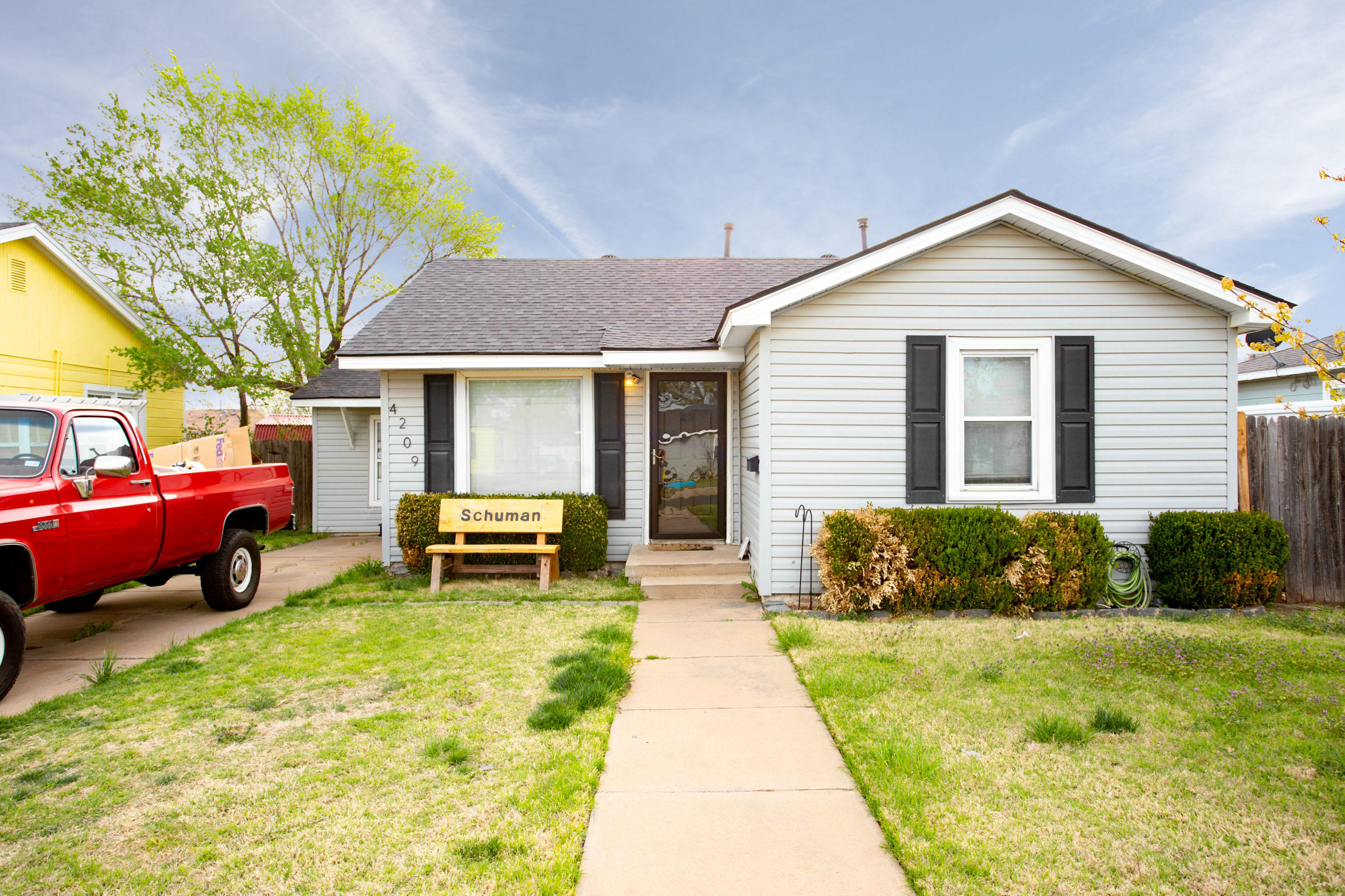 4209 South Jackson Street Amarillo, TX 79110 - Photo 1 of 18 a front view of a house with a garden and trees