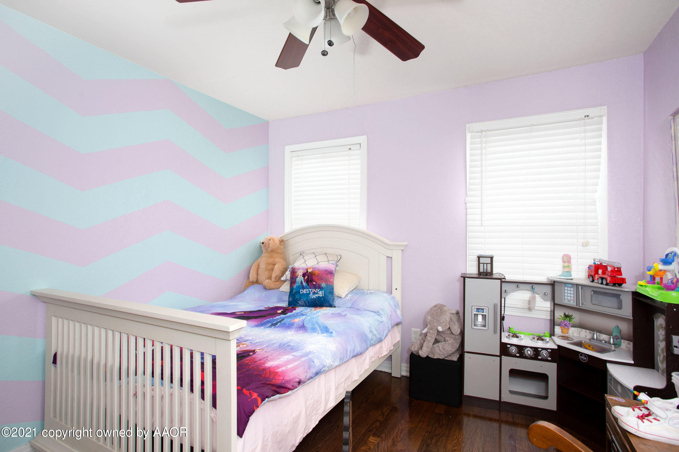 4209 South Jackson Street Amarillo, TX 79110 - Photo 13 of 18 a bedroom with a bed and wooden floor