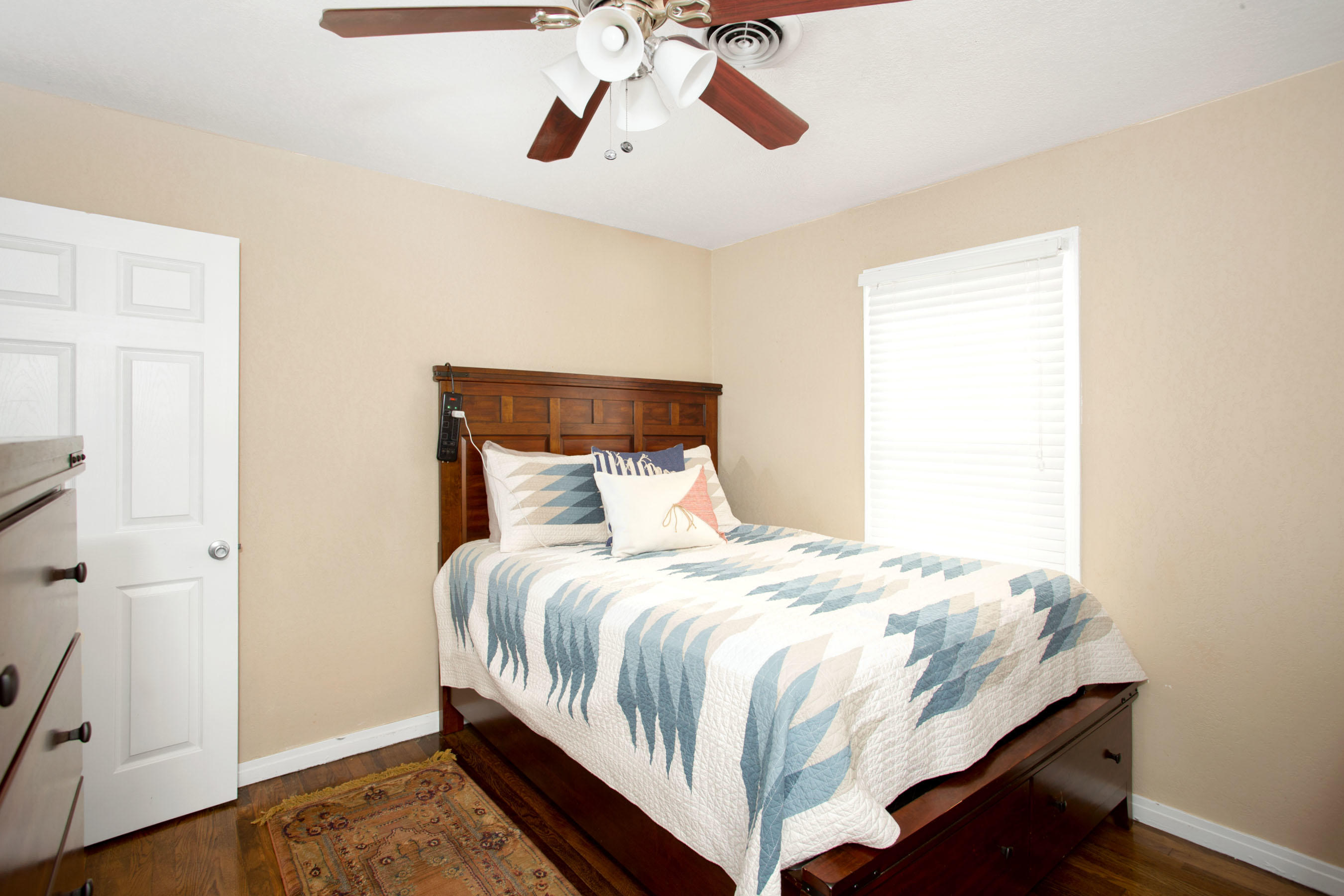 4209 South Jackson Street Amarillo, TX 79110 - Photo 10 of 18 a bedroom with a bed and wooden floor