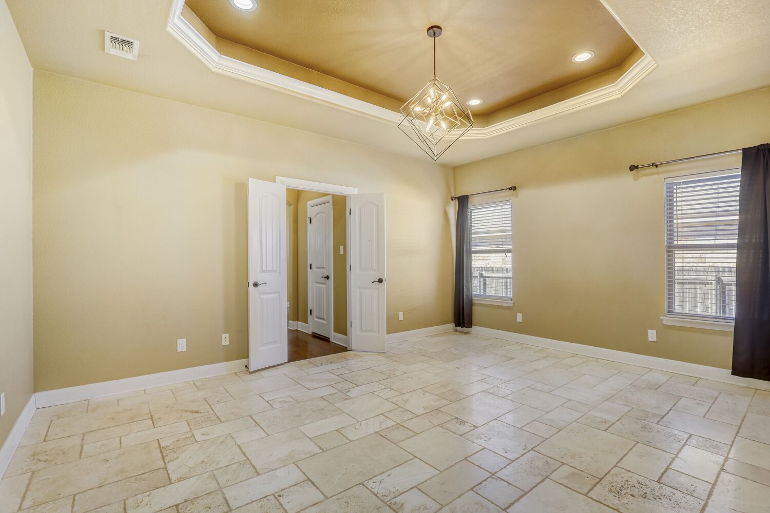 329 Jake Drive Jarrell, TX 76537 - Photo 10 of 17 Spare room with stone tile flooring, hanging lights, and a raised ceiling