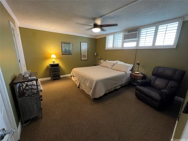 a bedroom with a bed and a couch