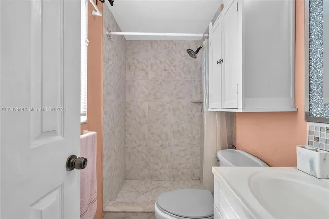 a bathroom with a toilet and shower