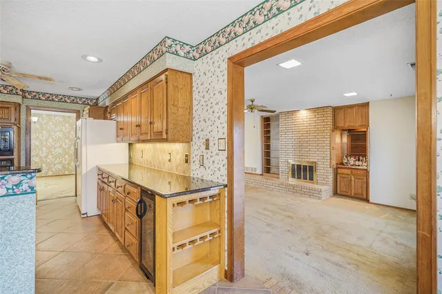 a picture of a room with a white wall and white refrigerator