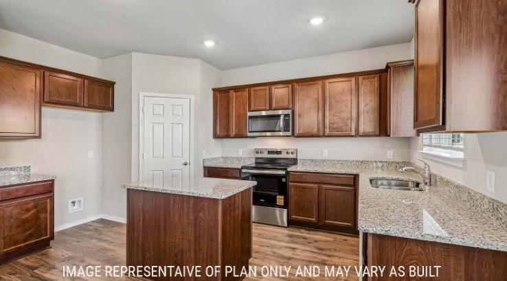 10101 Altair Drive Waco, TX 76708 - Photo 6 of 36 Kitchen featuring a central island, wood-finish cabinetry, granite countertops, stainless steel appliances, and recessed lighting