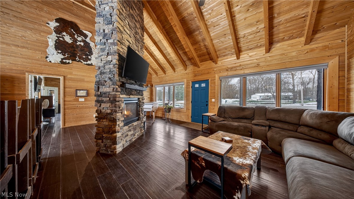 1693 Middleton Road Hudson, OH 44236 - Photo 8 of 48 Living room featuring wooden walls, dark wood-type flooring, a high wooden beamed ceiling, and a fireplace