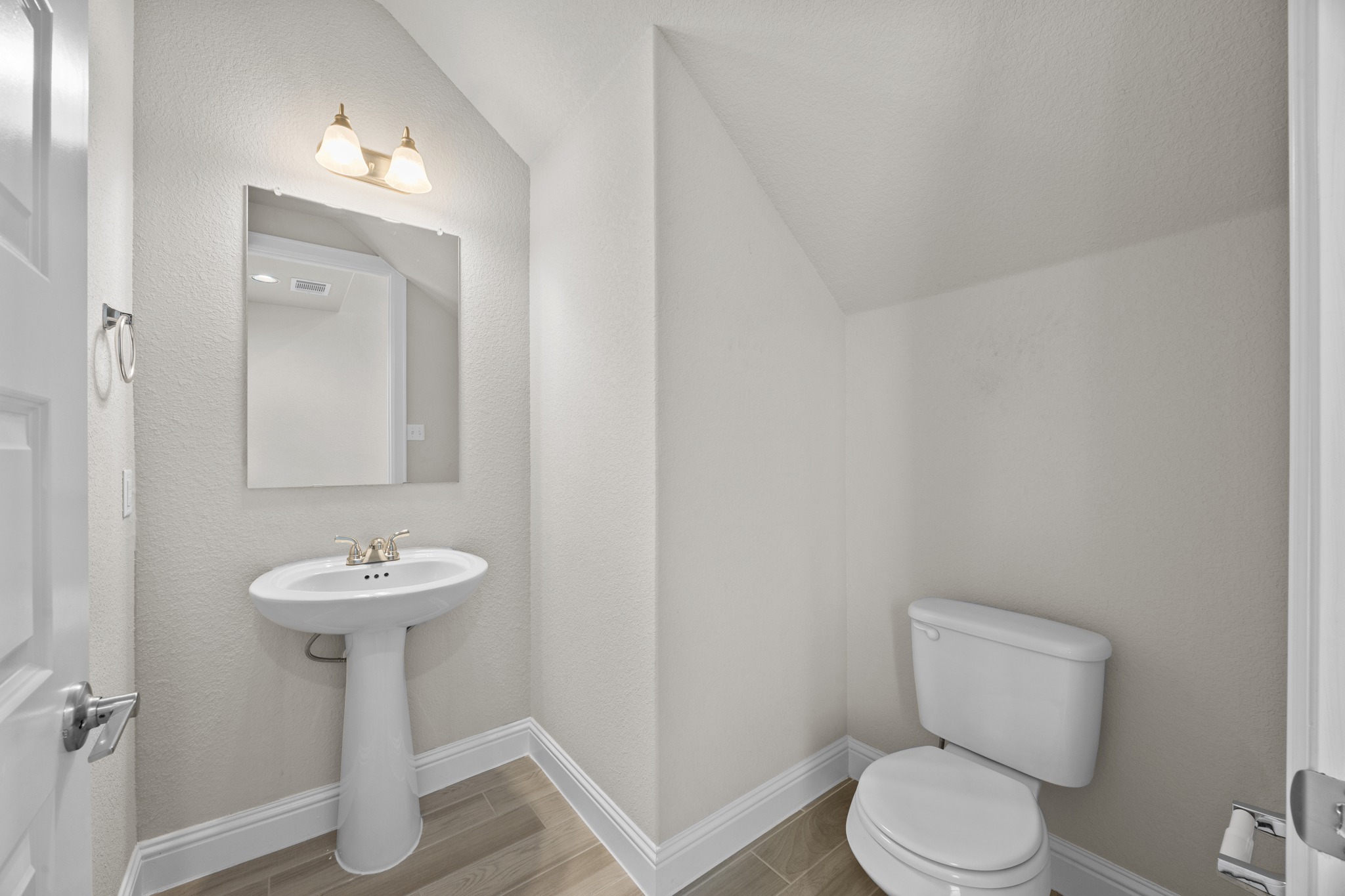 213 Graver Street Georgetown, TX 78626 - Photo 18 of 33 A well-appointed half bath features a pedestal sink and tile flooring.