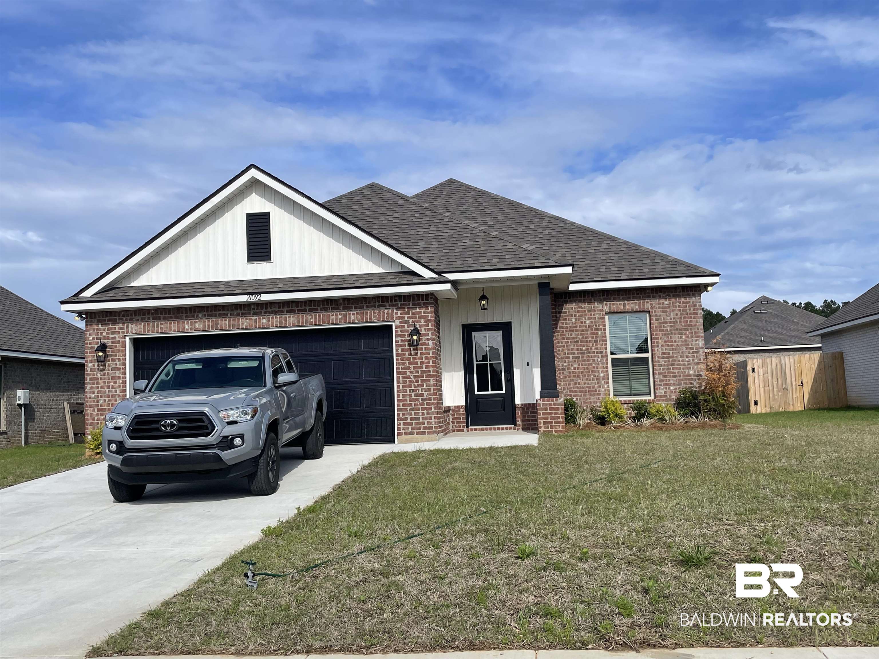 21092 Astoria Lane Silverhill, AL 36576 - Photo 1 of 3 View of front of house with brick siding, an attached garage, and concrete driveway