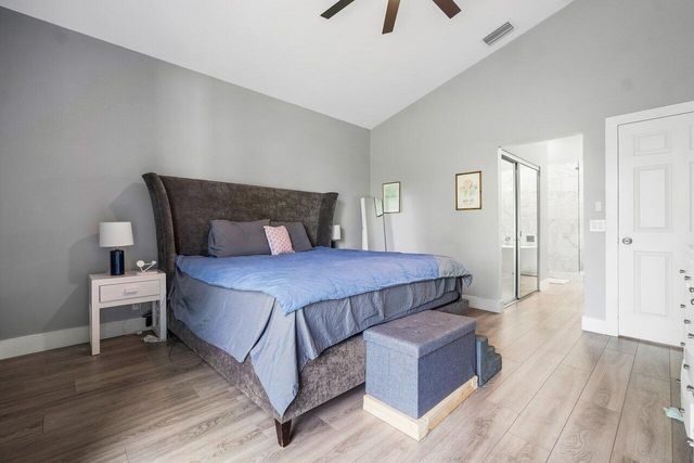 a bedroom with a bed and a night stand