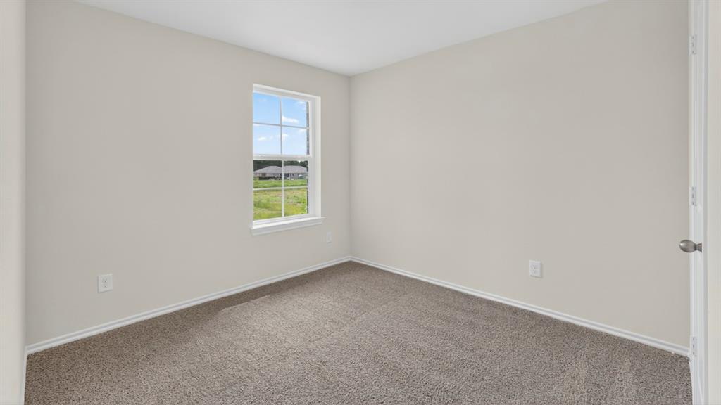1683 Mantle Road Crandall, TX 75114 - Photo 28 of 31 Neutral wall color, window with white trim, and gray carpet
