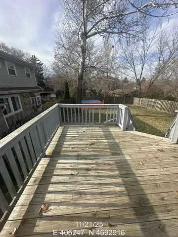 a view of balcony with wooden floor and fence