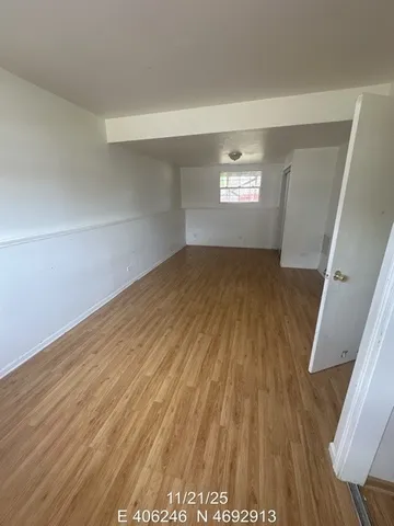 a view of wooden floor and windows in a room