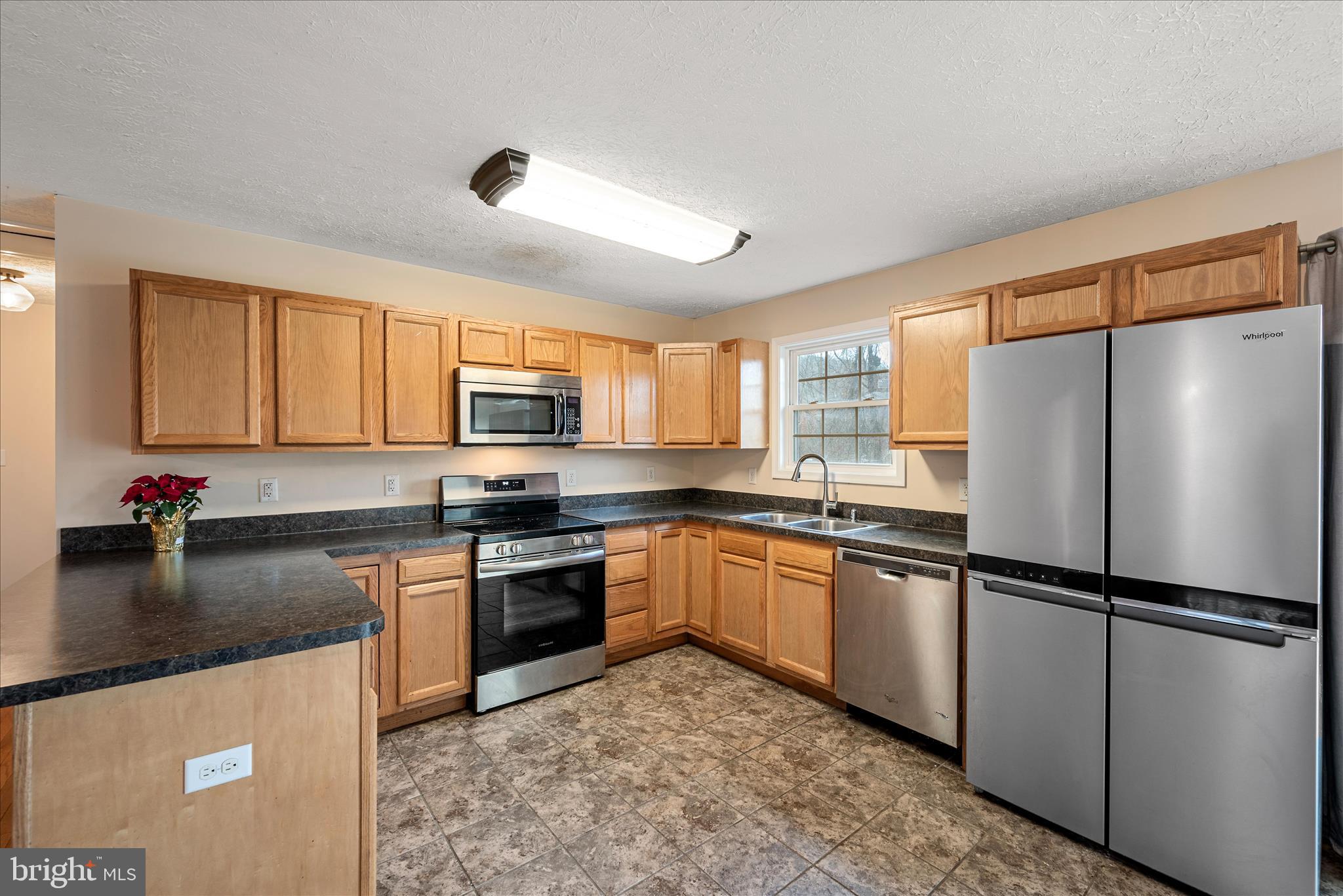 181 Brook View Road Front Royal, VA 22630 - Photo 8 of 47 a kitchen with granite countertop a refrigerator stove top oven a sink and dishwasher
