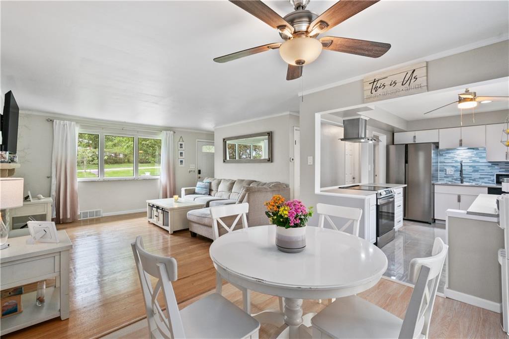 5431 Hamilton Road Gibsonia, PA 15044 - Photo 6 of 28 a dining room with furniture a window and wooden floor