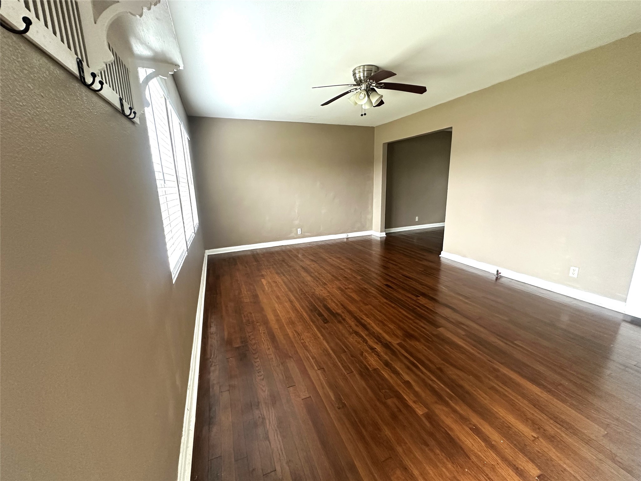 11005 Muscatine Street Houston, TX 77029 - Photo 3 of 12 a view of livingroom with hardwood floor and window