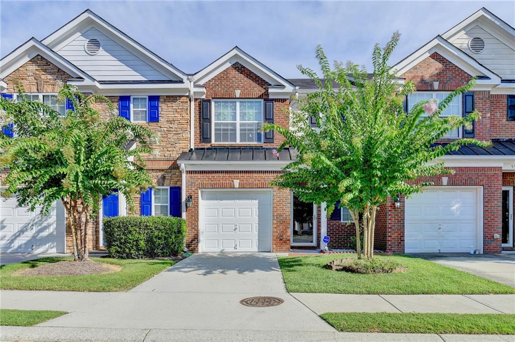5330 Langston Road Norcross, GA 30071 - Photo 1 of 1 a front view of a house with a yard and garage