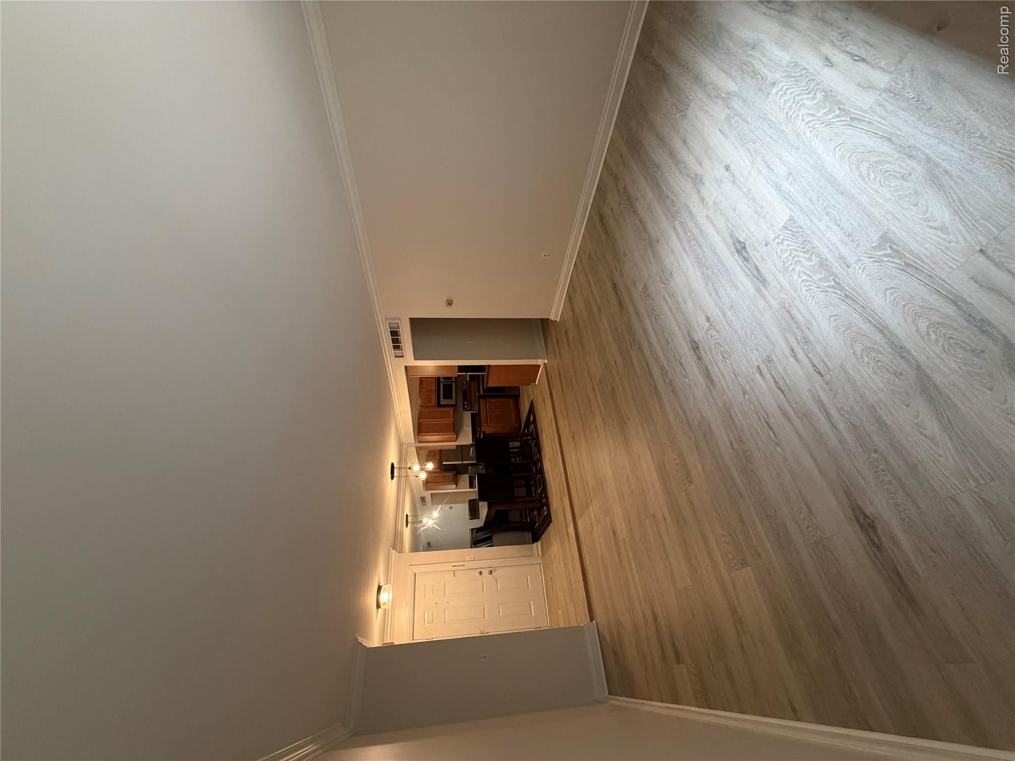 2245 Walton Blvd., Unit 56 Rochester, MI 48309 - Photo 7 of 15 Light wood-finish flooring throughout, crown molding details, and recessed lighting