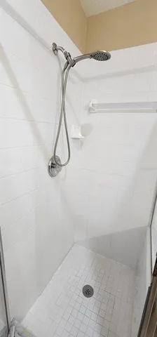 a white toilet sitting next to a white wall