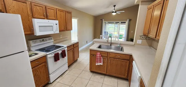 a view of an empty room and a window