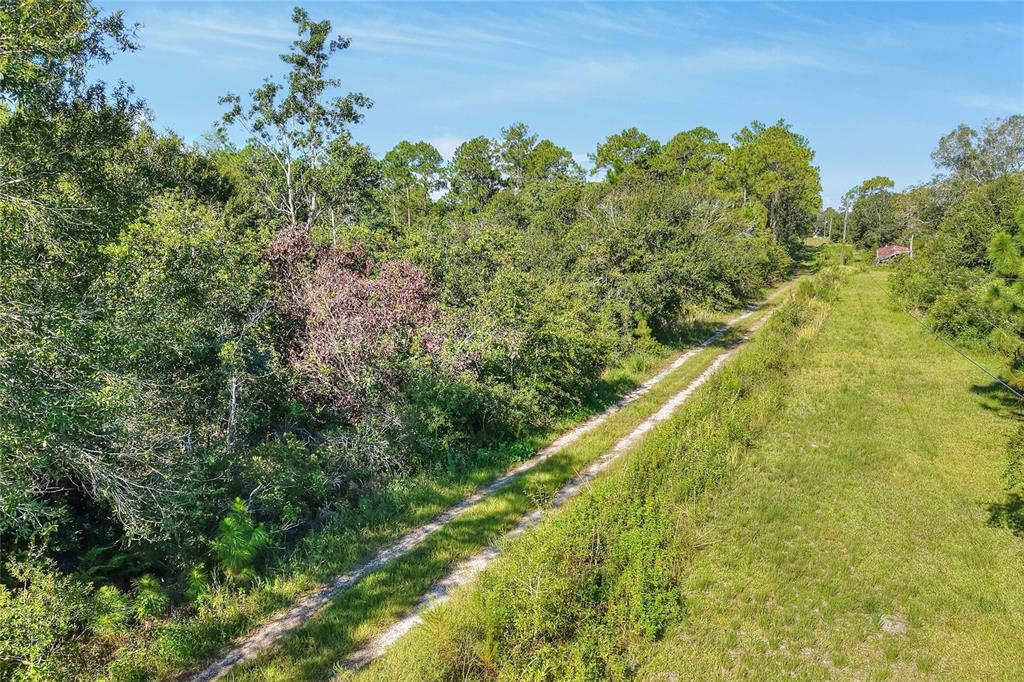 730 McClellan Road Frostproof, FL 33843 - Photo 14 of 50 a view of a yard with an outdoor space