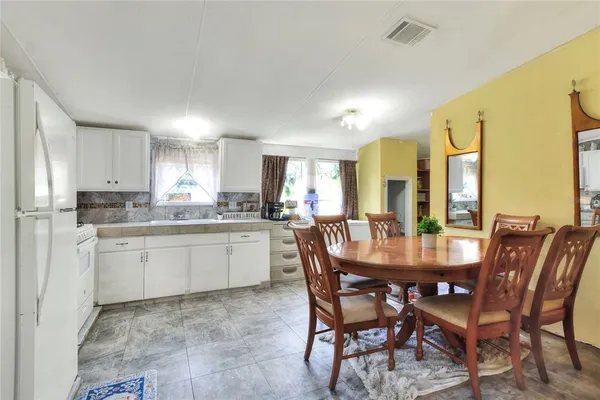 a view of a dining room with furniture and window