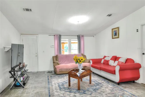 a living room with furniture and flowers