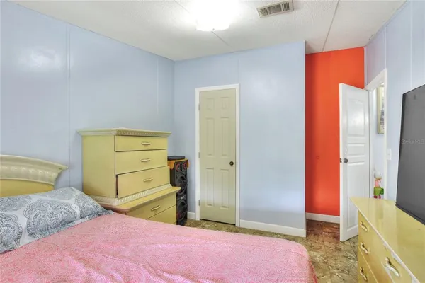 a bedroom with a bed and a dresser