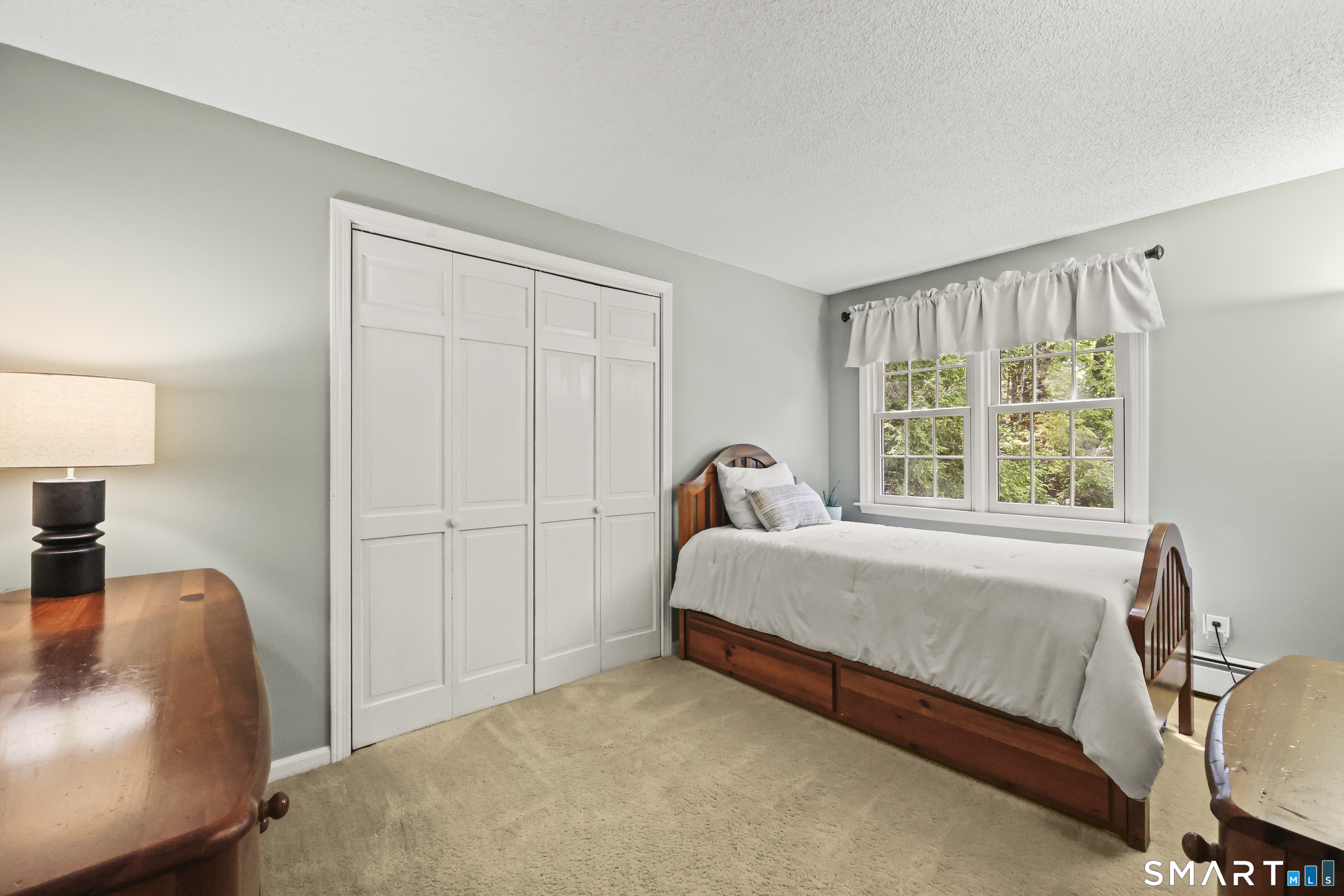 17 Briar Hill Road Avon, CT 06001 - Photo 13 of 38 This bedroom has a closet that expands the width of the room with views of the backyard.