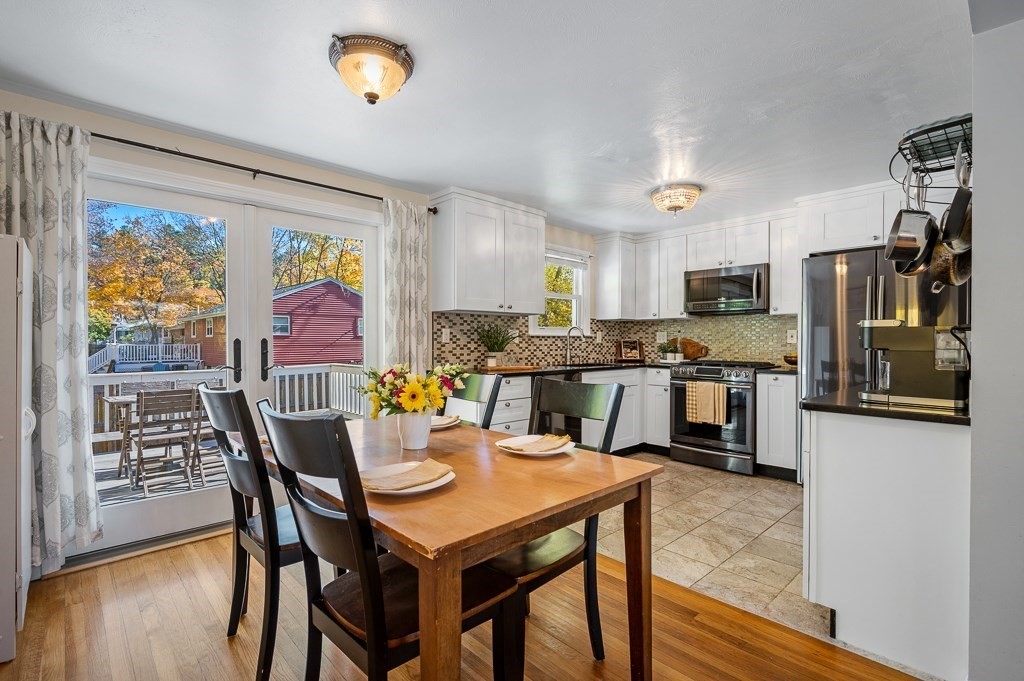104 Conrad Road Marlborough, MA 01752 - Photo 11 of 34 a kitchen with a table chairs refrigerator and microwave