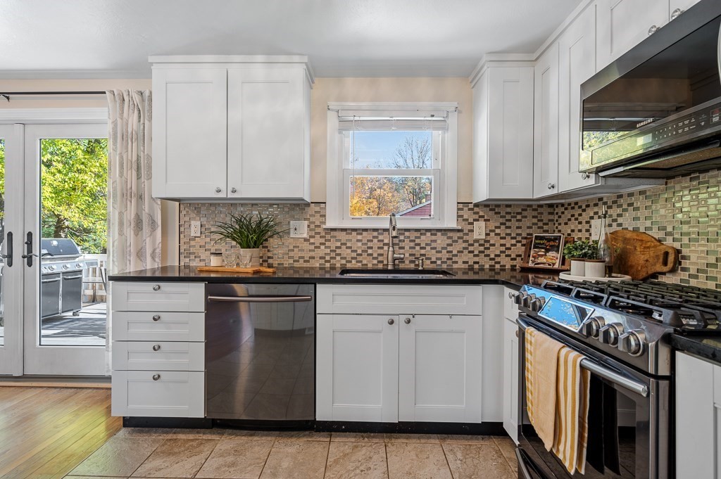 104 Conrad Road Marlborough, MA 01752 - Photo 12 of 34 a kitchen with stainless steel appliances granite countertop a sink stove and cabinets