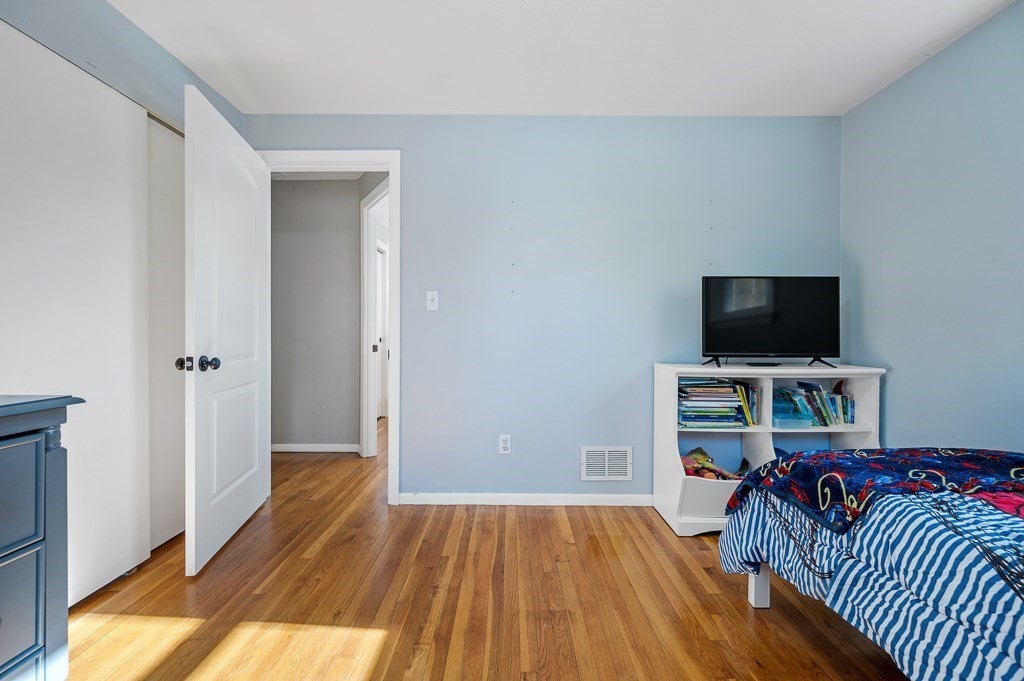 104 Conrad Road Marlborough, MA 01752 - Photo 16 of 34 a view of a livingroom with wooden floor and a flat screen tv