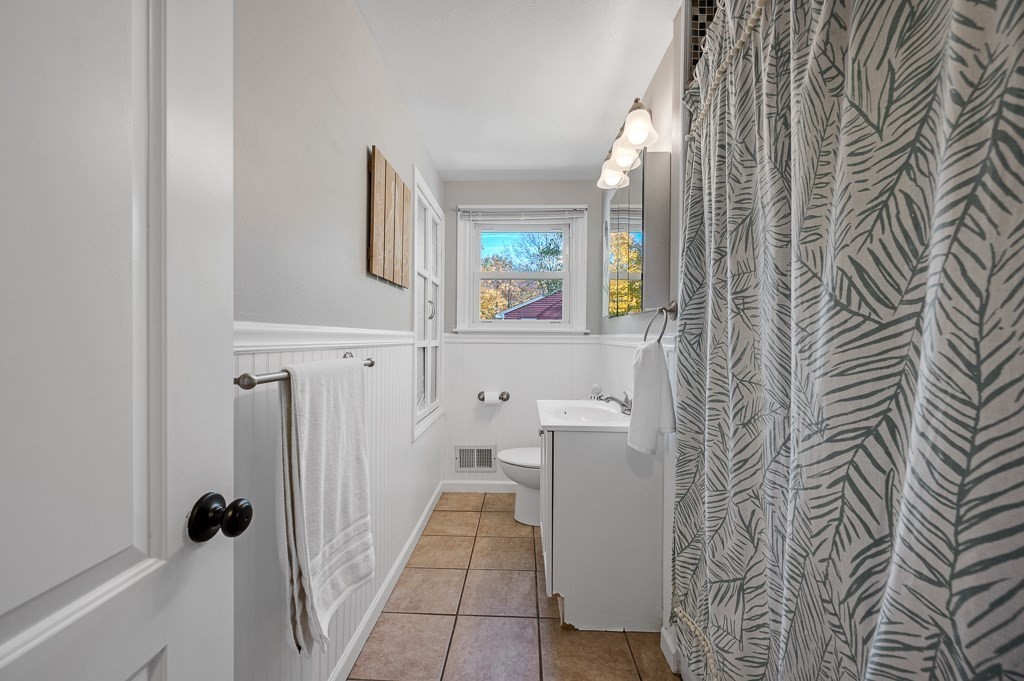 104 Conrad Road Marlborough, MA 01752 - Photo 17 of 34 a bathroom with a sink and mirror with toilet