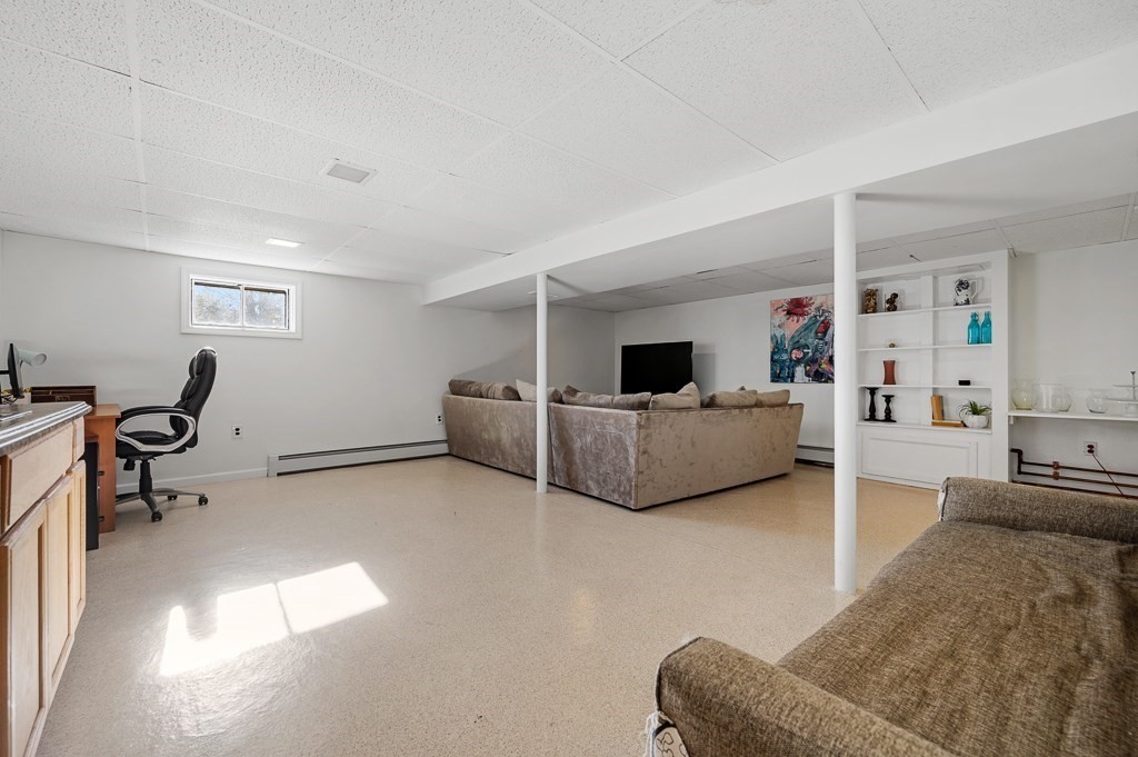 104 Conrad Road Marlborough, MA 01752 - Photo 22 of 34 a living room with furniture and a lamp
