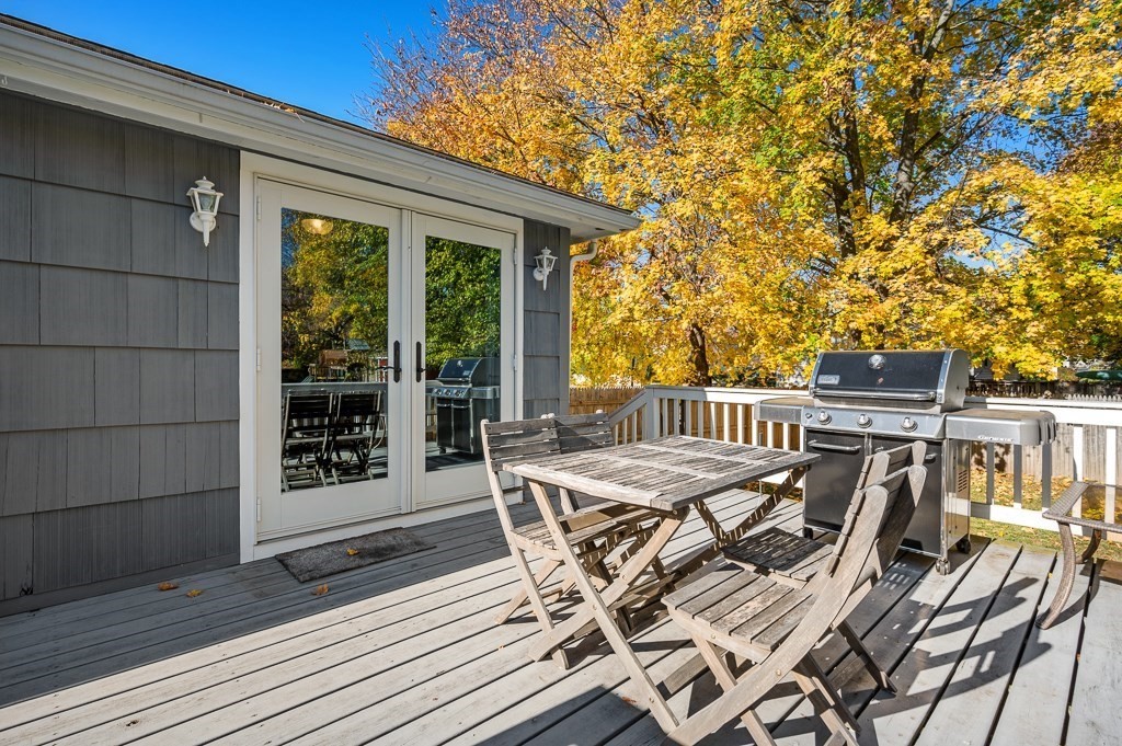 104 Conrad Road Marlborough, MA 01752 - Photo 28 of 34 a view of a roof deck with table and chairs with wooden floor and fence