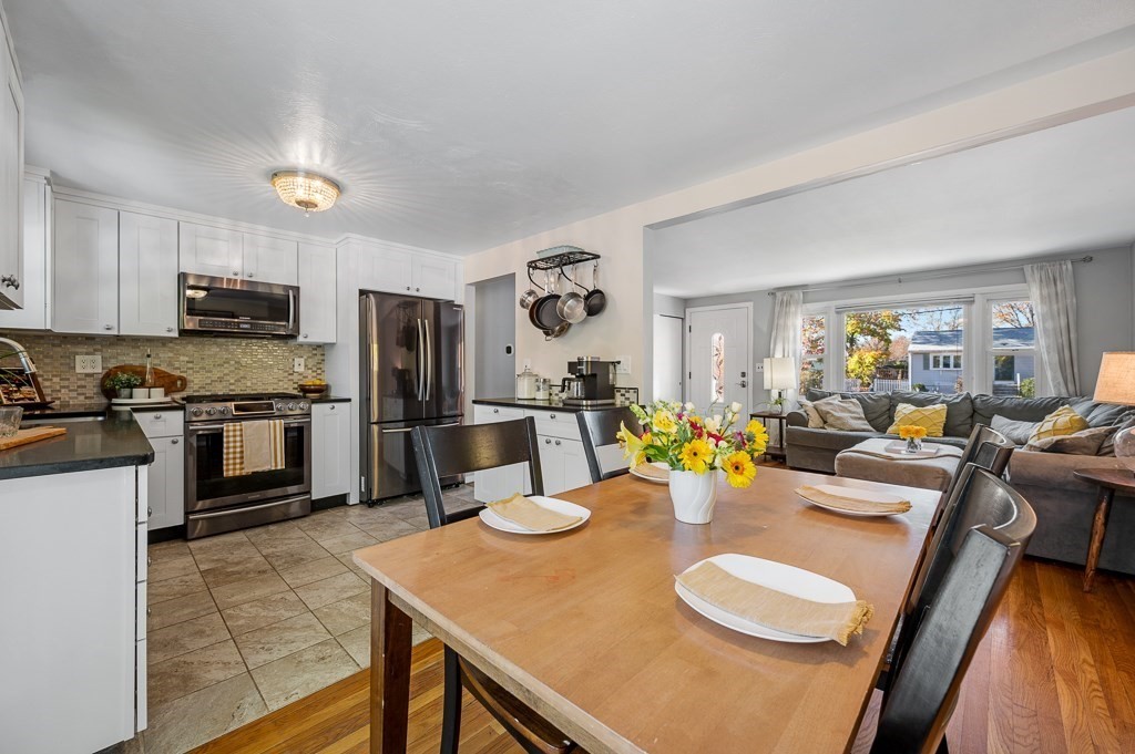 104 Conrad Road Marlborough, MA 01752 - Photo 8 of 34 a kitchen with stainless steel appliances granite countertop a stove a kitchen island a dining table and chairs