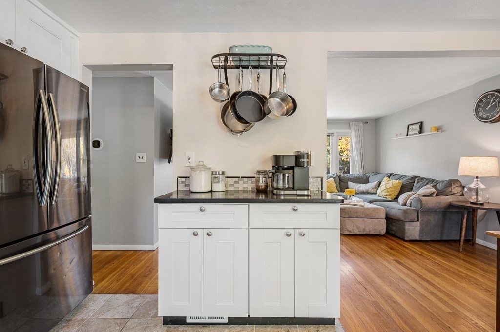104 Conrad Road Marlborough, MA 01752 - Photo 10 of 34 a living room with kitchen island furniture a refrigerator and a sink