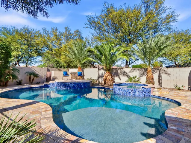 a front view of a house with garden and patio
