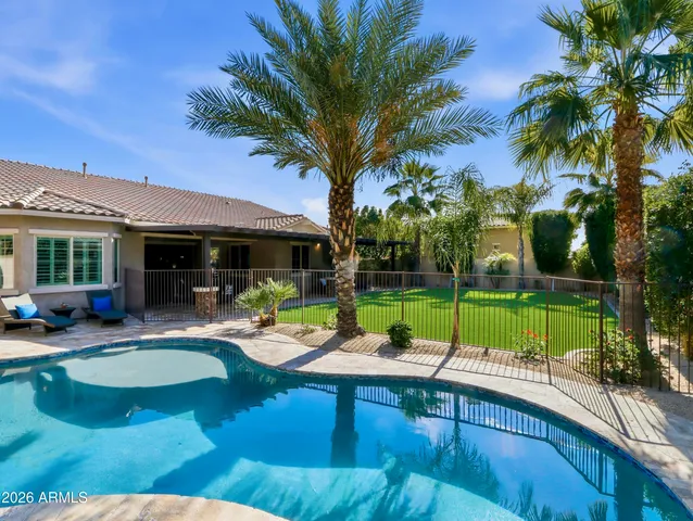 a view of a swimming pool with a table and chairs