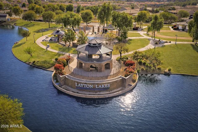 a view of a hallway with wooden floor and a bathroom
